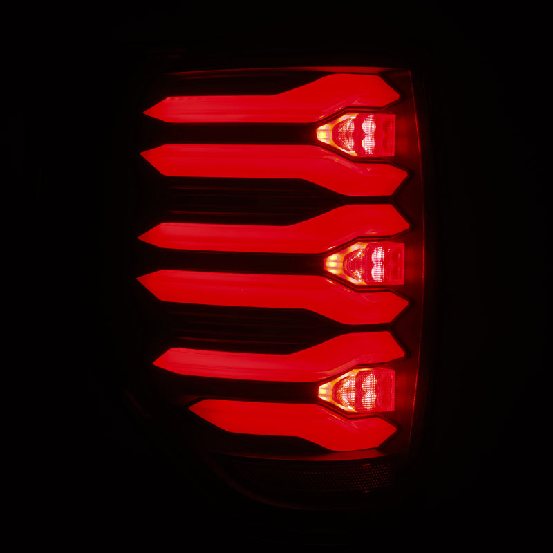 AlphaRex LUXX LED taillights for 09-14 Ford F150 with black housing showcasing bright red illumination.