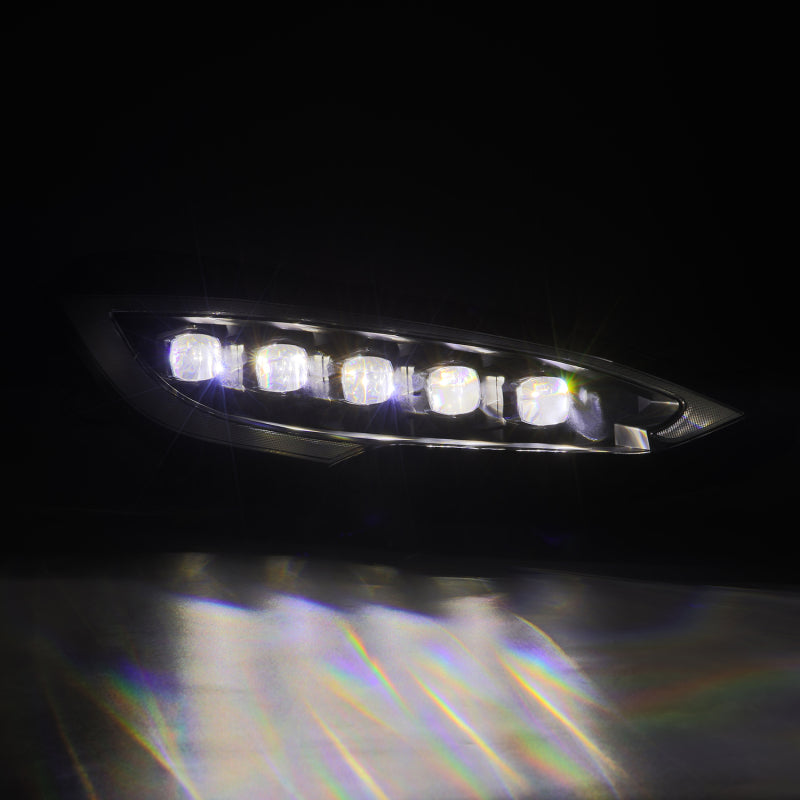 AlphaRex NOVA-Series LED projector headlights for 12-21 Tesla Model S, featuring black housing and sequential signal lights.