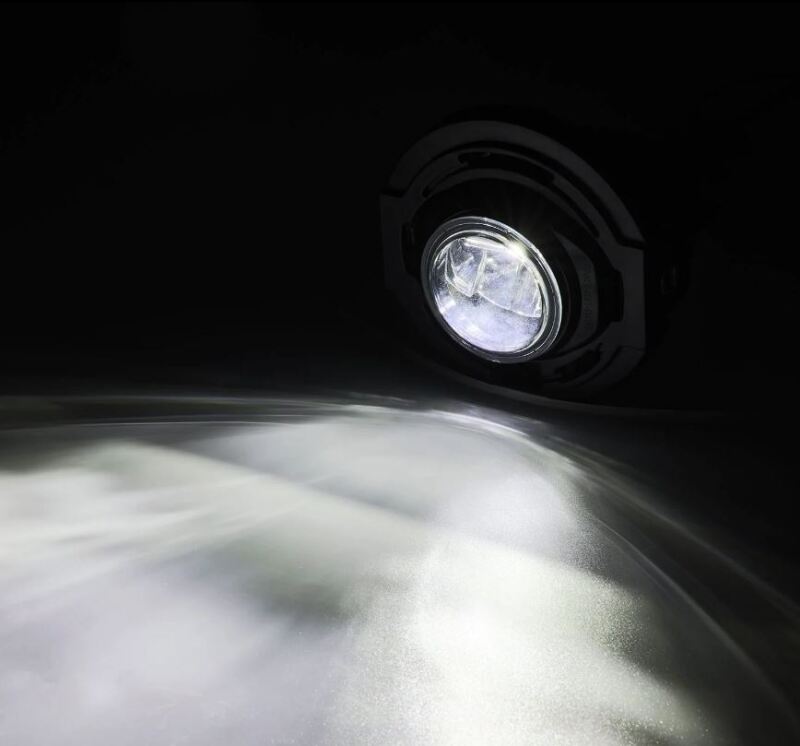 AlphaRex Dodge Charger DoubleTap dual color LED projector fog light illuminating a surface with bright white light.