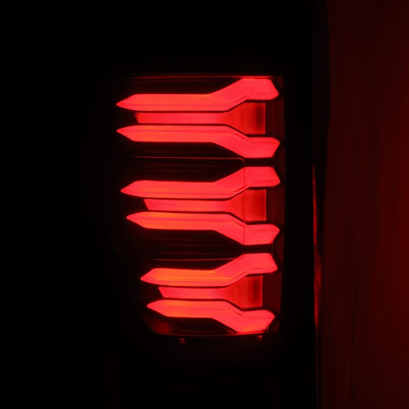 AlphaRex LUXX LED taillights for 21-22 Ford F-150 in black and red, featuring a modern design with bright LED illumination.