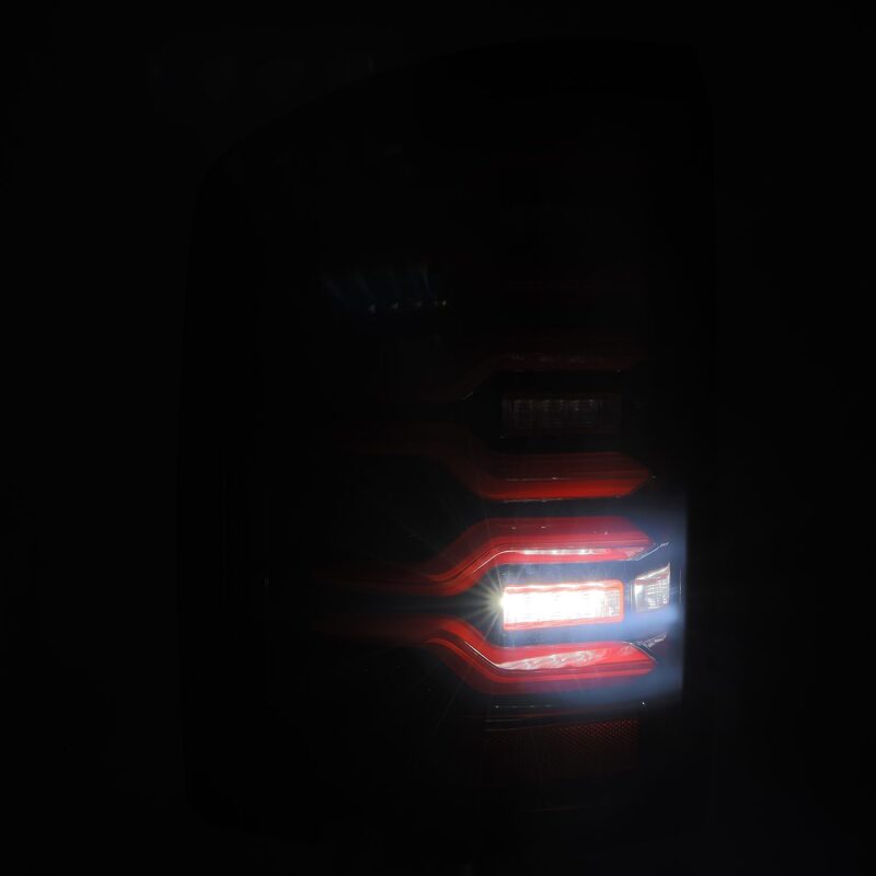AlphaRex LUXX-Series LED tail lights for 14-18 GMC Sierra, featuring black and red design with sequential signaling.