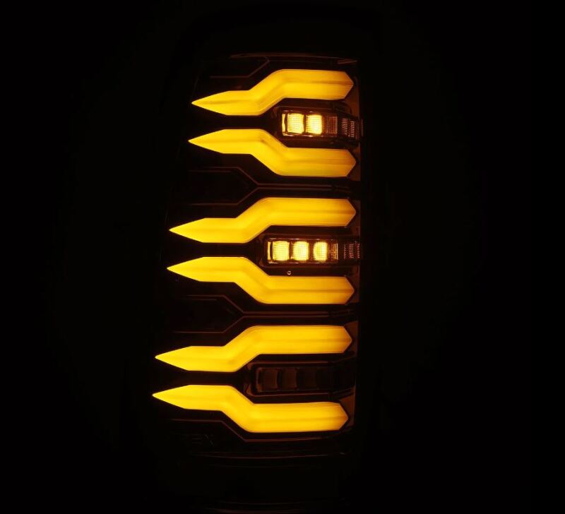 AlphaRex LUXX-Series LED tail lights for 99-06 Chevrolet Silverado Sierra in alpha-black with distinctive amber lighting.