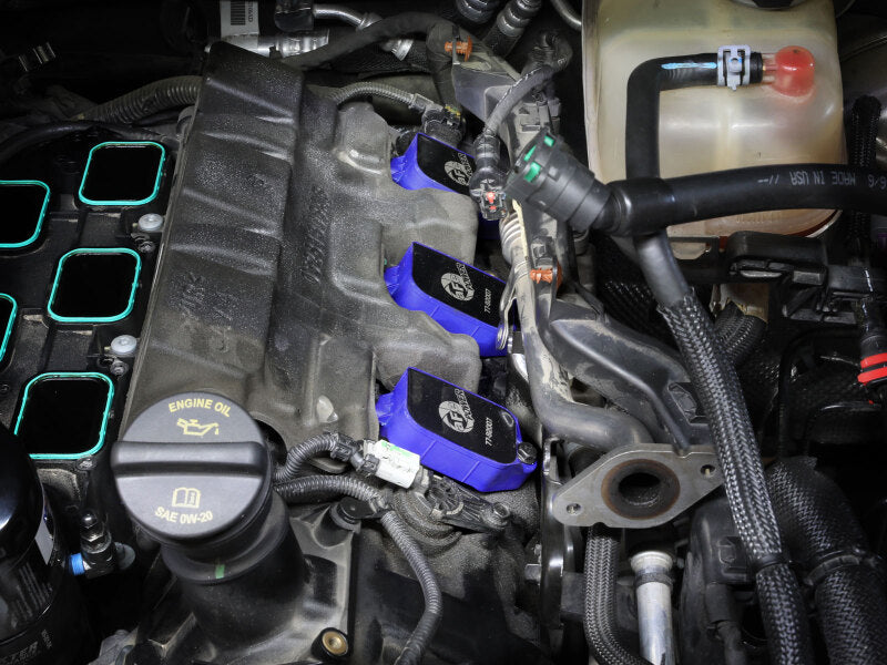 afe SCORCHER ignition coils installed in a Dodge/Jeep/RAM engine, enhancing performance for V6-3.6L models from 2016 to 2025.