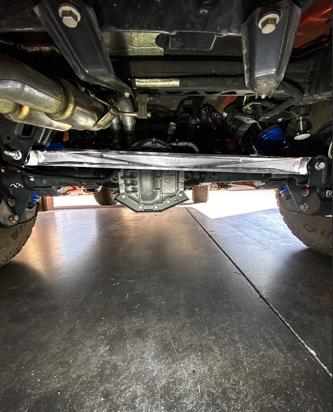 2021+ Bronco billet panhard bar with ultra-flex joint installed under the vehicle, showcasing suspension components.
