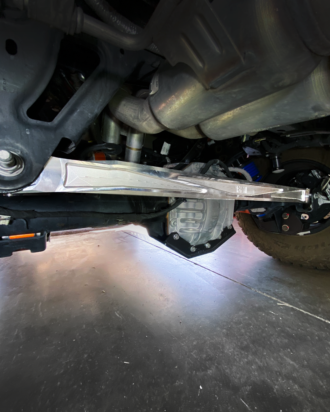 2022+ Bronco Raptor billet panhard bar with ultra-flex joint installed under the vehicle, showcasing durable construction and performance.