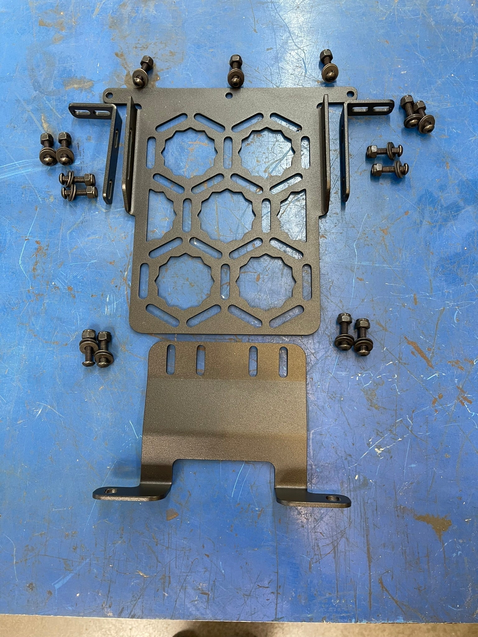 Bronco Raptor 2022 Inside Front Roof Mount by Adapt-A-Panel with mounting hardware on a blue work surface.