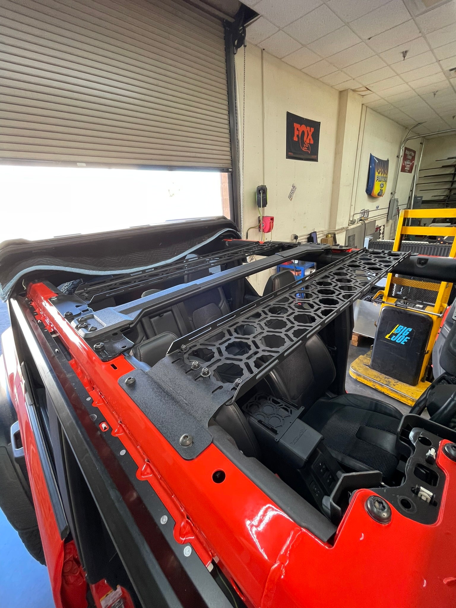 Inside view of a 2021 Bronco showing the Adapt-A-Panel roof panel mount installed across the front section.