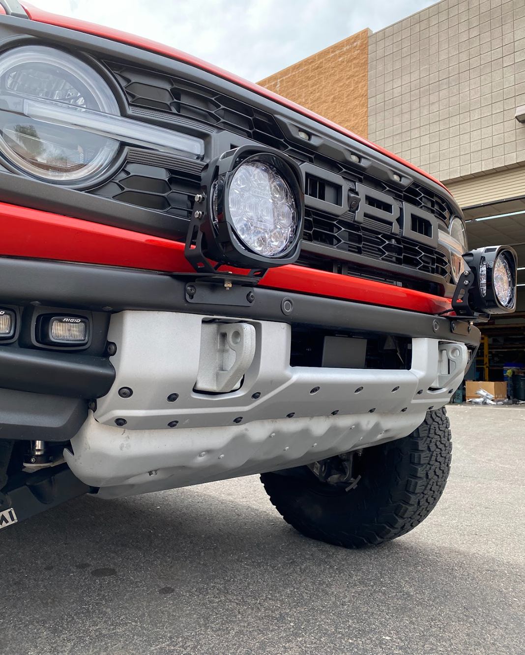 Light mount brackets for 2022-2024 Bronco Raptor, installed on stock modular bumper, showcasing offroad lighting setup.