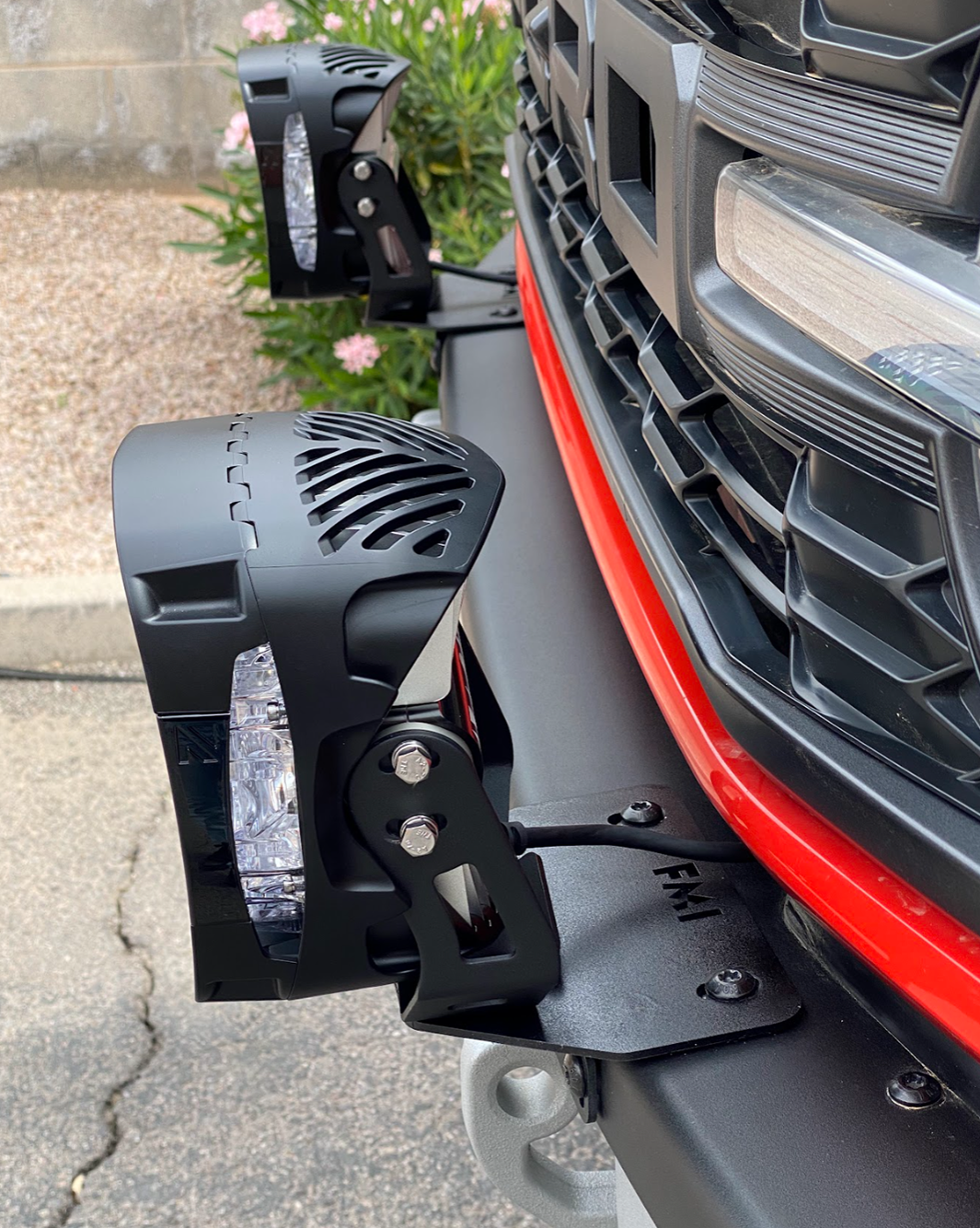 Pair of light mount brackets installed on a 2022-2024 Bronco Raptor's stock modular bumper, showcasing offroad lighting.