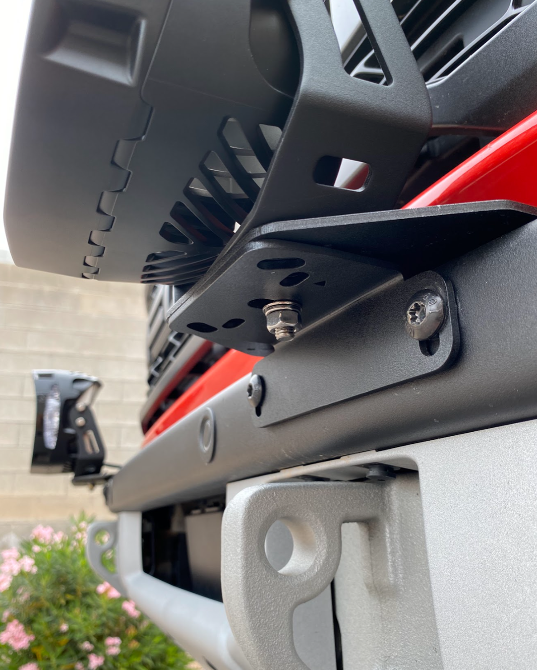 Close-up of 2022-2024 Bronco Raptor light mount brackets installed on a stock modular bumper, showcasing secure attachment points.