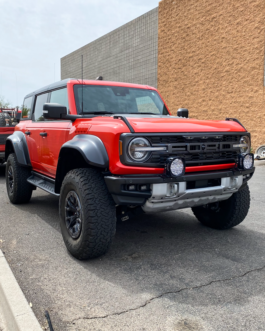 2022-2024 Bronco Raptor with light mount brackets installed on stock modular bumper, showcasing offroad readiness.