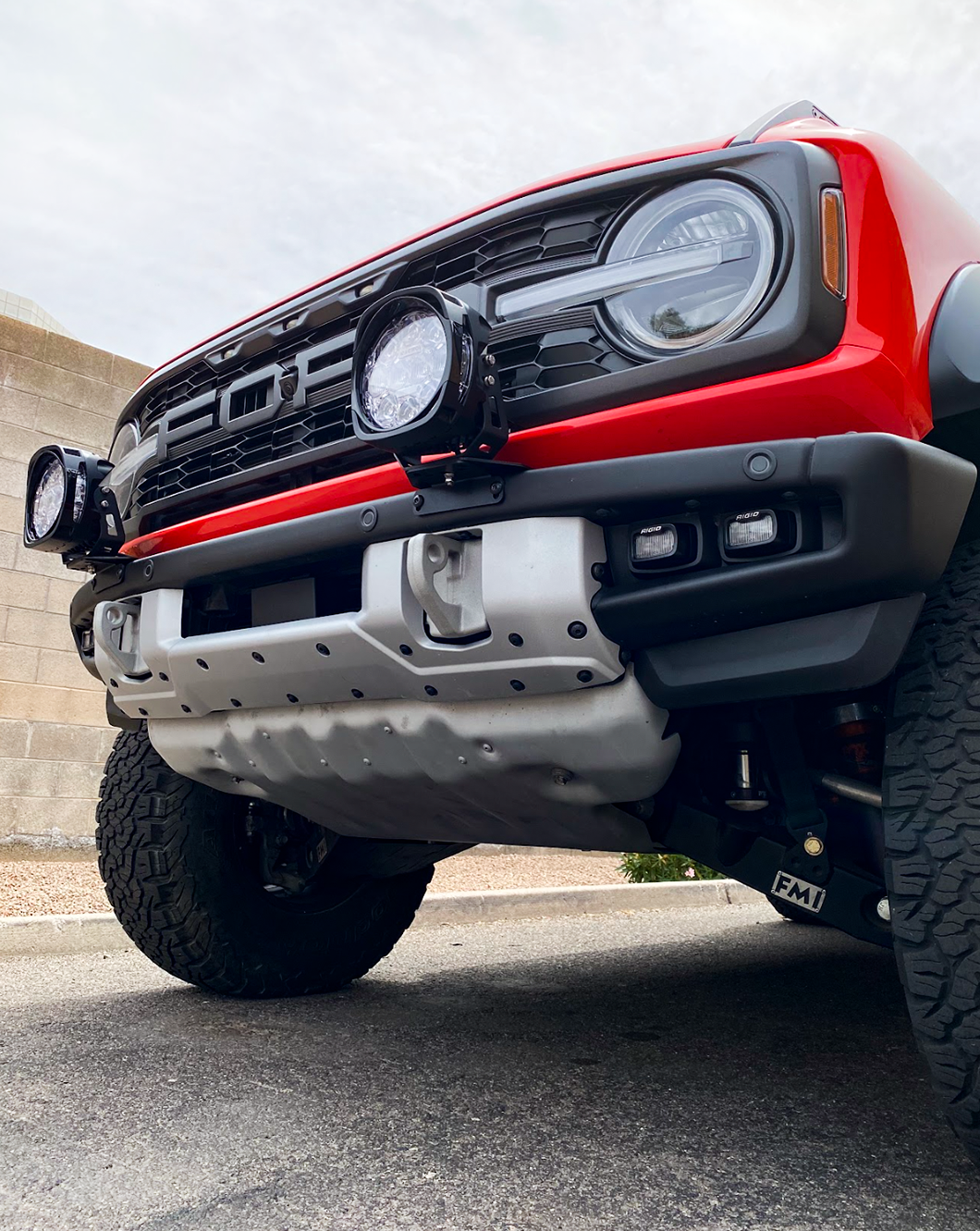 Bronco Raptor with light mount brackets installed on stock modular bumper, showcasing offroad readiness and style.