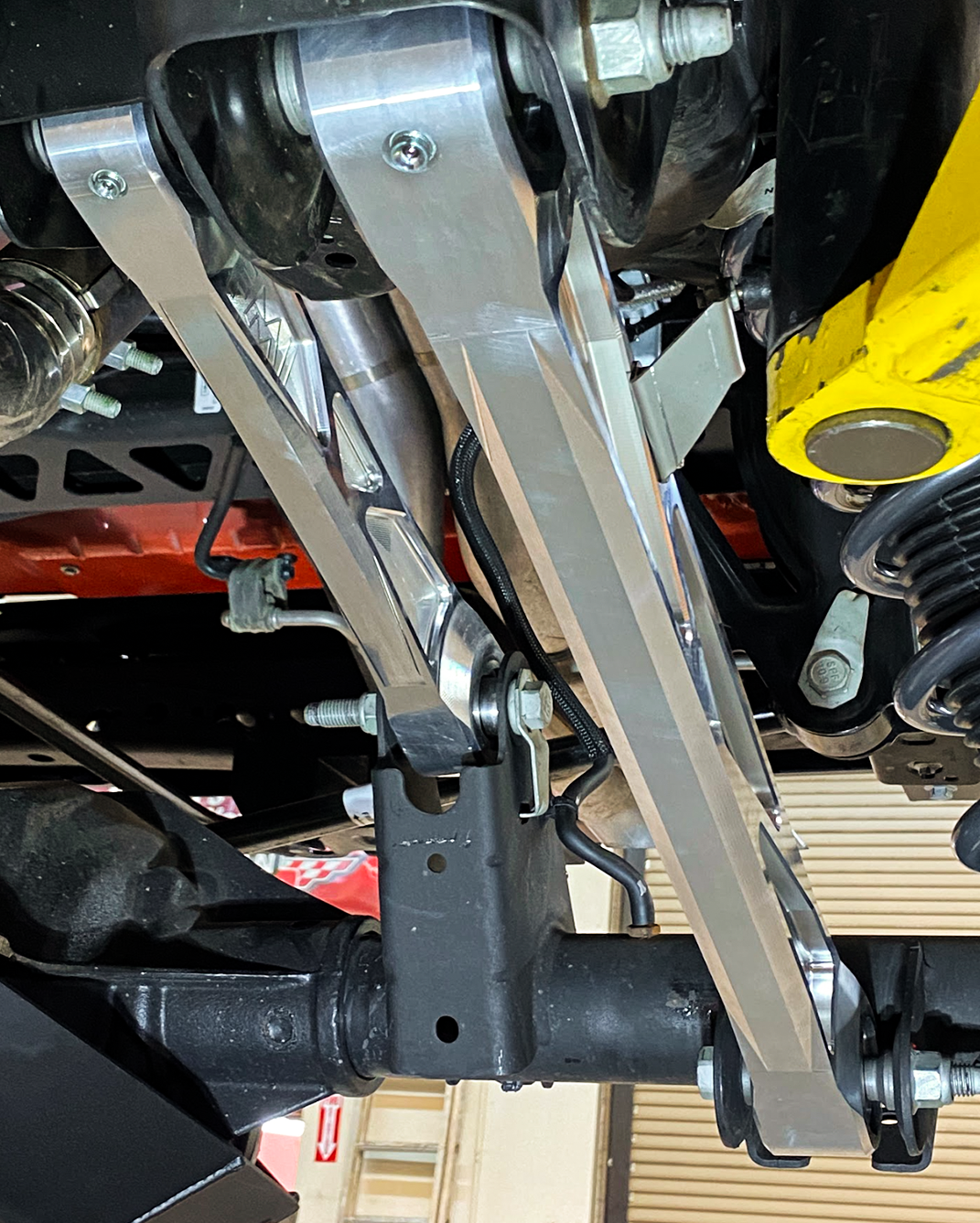 Billet aluminum rear suspension arms with ultra-flex joints installed on a 2022 Bronco Raptor, showcasing durability and performance.