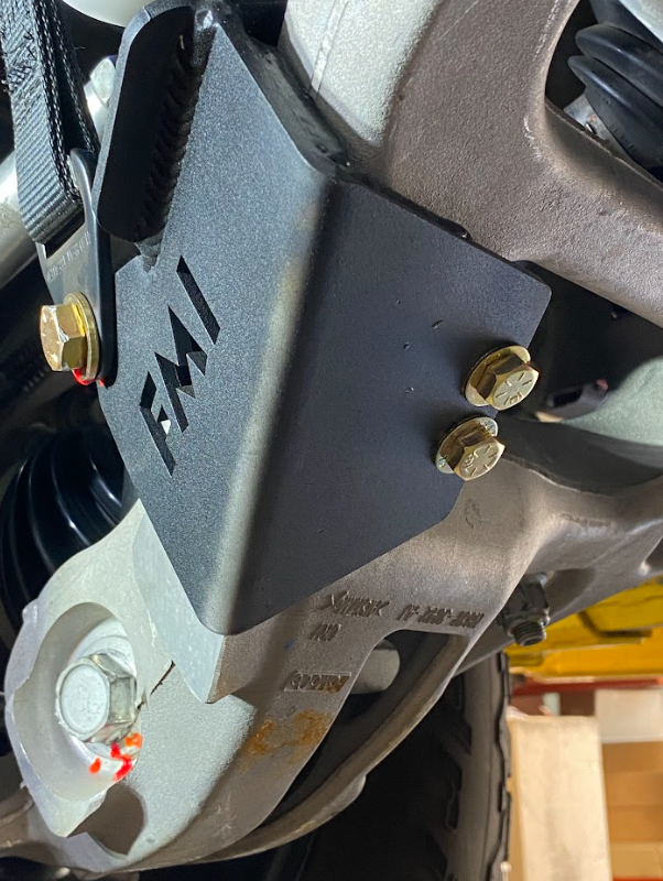 Front limit strap and bump stop for 2022+ Bronco Raptor, mounted on stock lower arm for enhanced suspension performance.