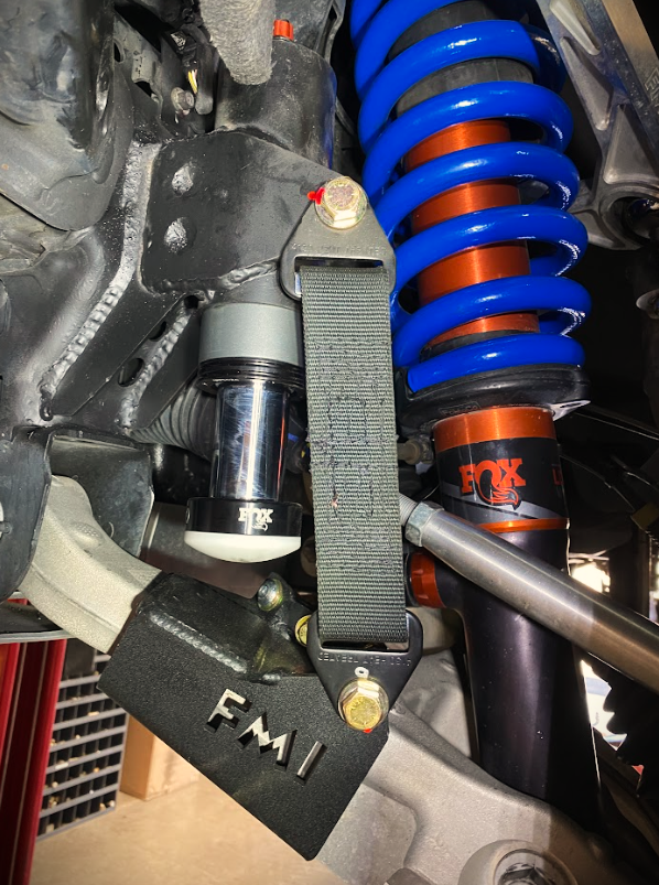 Front limit strap and bump stop for 2022+ Bronco Raptor, showcasing stock lower arm and suspension components.