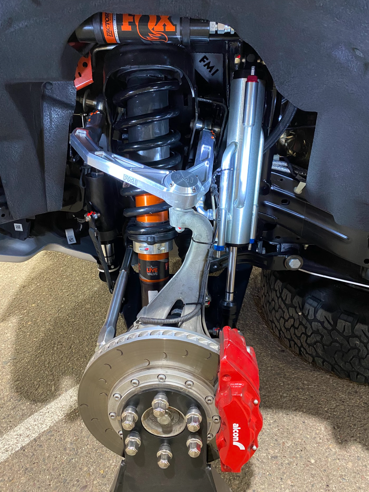 2022 Bronco Raptor mid travel front suspension kit showcasing high-performance components and upgraded brake system.