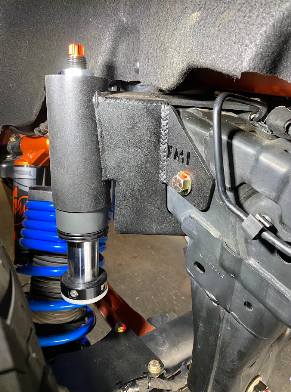 Rear hydraulic bump stop kit installed on a Bronco Raptor, showcasing its robust design and suspension components.