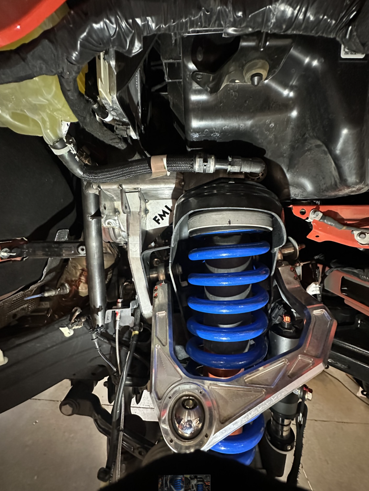 2022+ Bronco Raptor fabricated front bypass shock mount kit showcasing blue shock and mounting components.