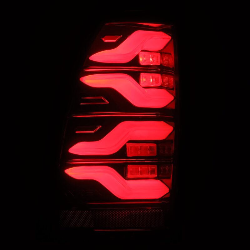 AlphaRex LUXX LED taillights for 05-15 Toyota Tacoma in black and red with sequential signal and activation light.