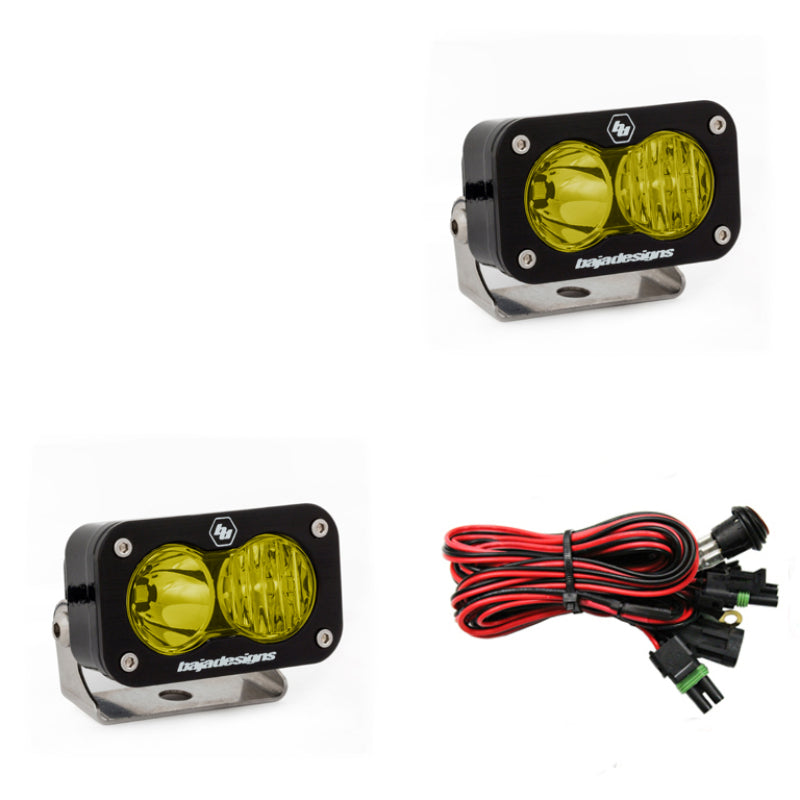 Baja Designs S2 Pro amber LED driving lights with mounting brackets and wiring harness for offroad vehicles.