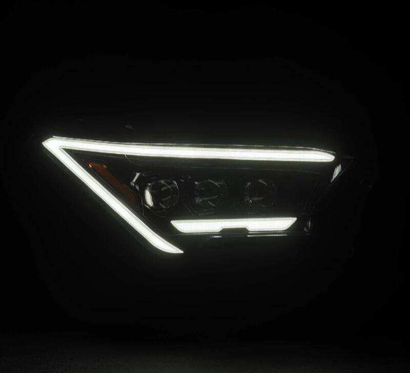 AlphaRex 2024 Toyota Tacoma NOVA-Series projector headlights in black with activation light, showcasing a sleek design.