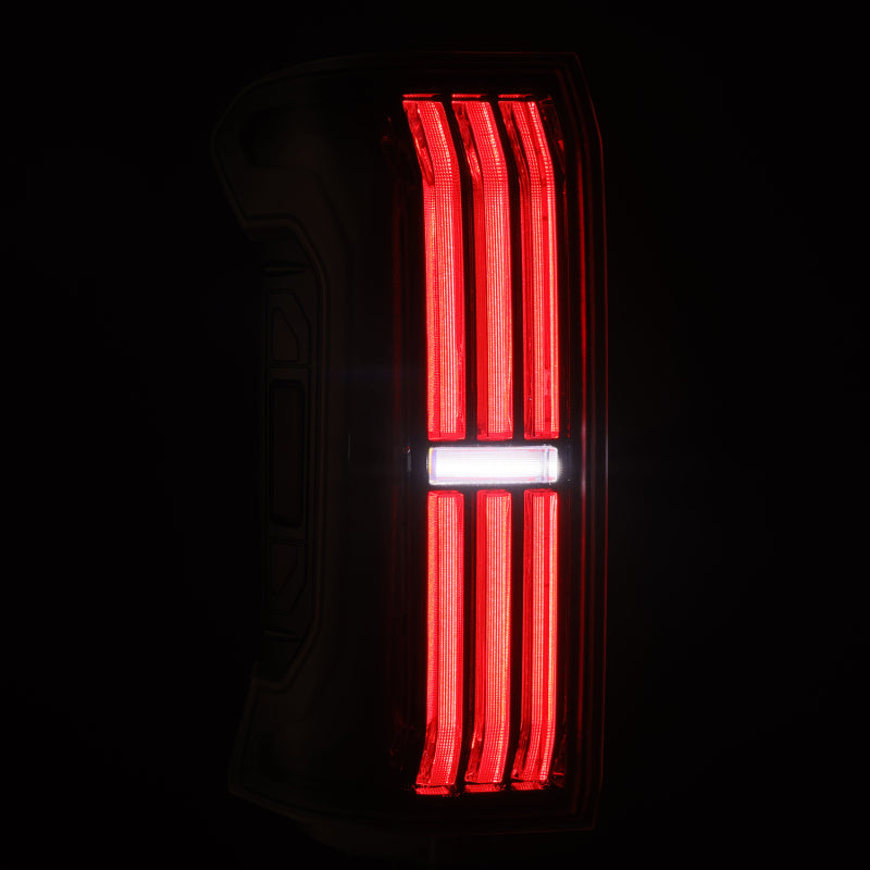 AlphaRex NOVA-Series LED prismatic tail lights for 24-25 Toyota Tacoma in black, featuring a sleek design with bright red illumination.