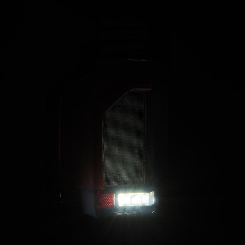 AlphaRex LUXX-Series LED tail lights for 19-24 Chevy Silverado 1500 and 20-24 2500HD/3500HD in red, showcasing modern design.