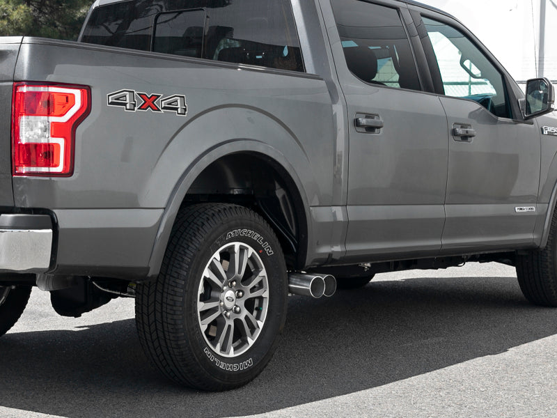 A Ford F-150 with a Rebel Series DPF-Back Exhaust System installed, showcasing dual exhaust tips and a sleek design.