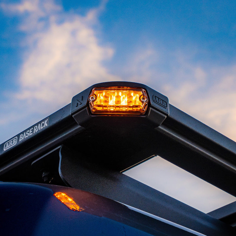 ARB Nacho Nano Base Rack Corner Cap 4-Light Kit mounted on a vehicle, featuring a sleek design with bright amber lights.
