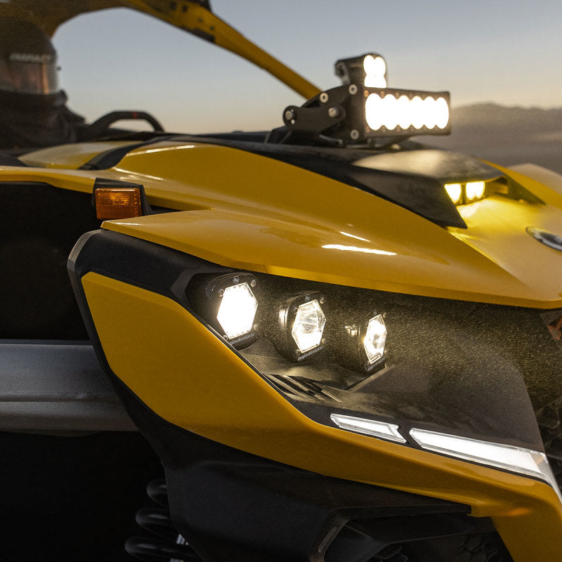 Baja Designs 2024+ Can-Am Maverick R S1 Headlight Kit showcasing bright, hexagonal headlights on a yellow UTV.
