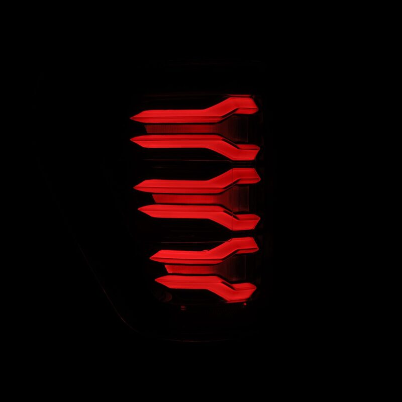 AlphaRex 21-22 Ford F150 LUXX LED projector tail lights in Alpha-Black, featuring a sleek, modern design with bright red illumination.