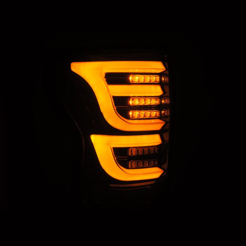 AlphaRex LUXX-Series LED tail lights for 07-13 Toyota Tundra in Alpha-Black with bright orange illumination.