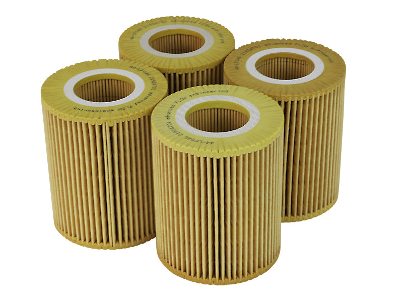Four afe PROGUARD oil filters showcasing a pleated design for enhanced filtration and engine protection.