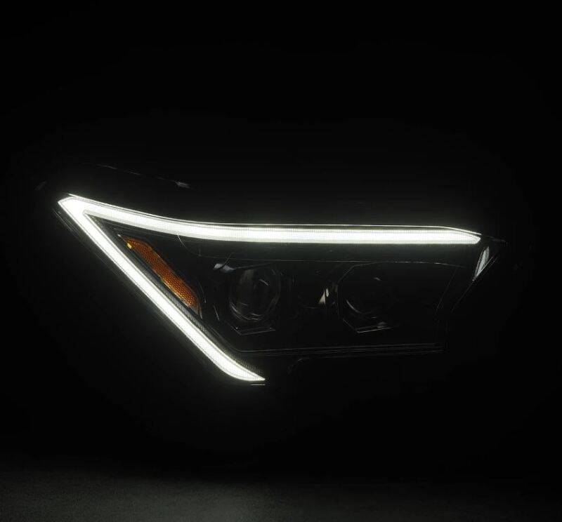 AlphaRex 2024 Toyota Tacoma LUXX-Series projector headlights featuring a sleek design with LED accents for enhanced visibility.