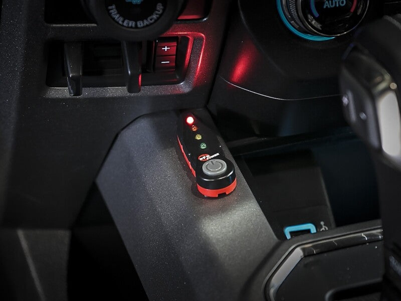 AFE SCORCHER Power Module installed in a GM truck's interior, featuring LED indicators and a power button.
