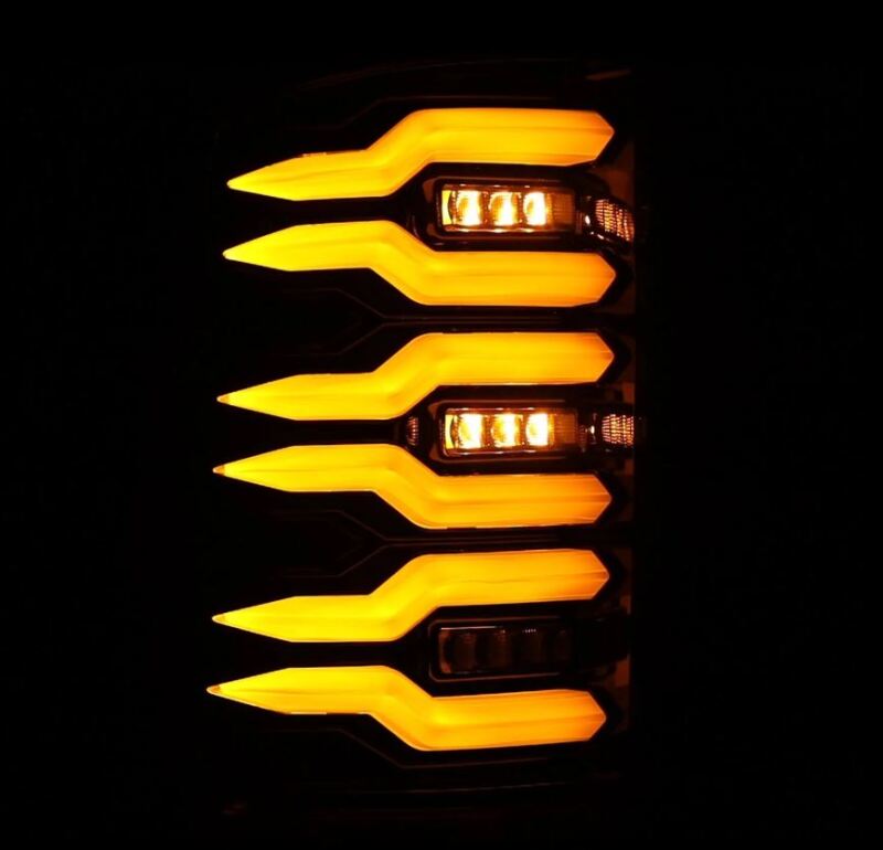 AlphaRex Luxx Series LED tail lights for 07-13 GMC Sierra, featuring an alpha black design with bright amber accents.