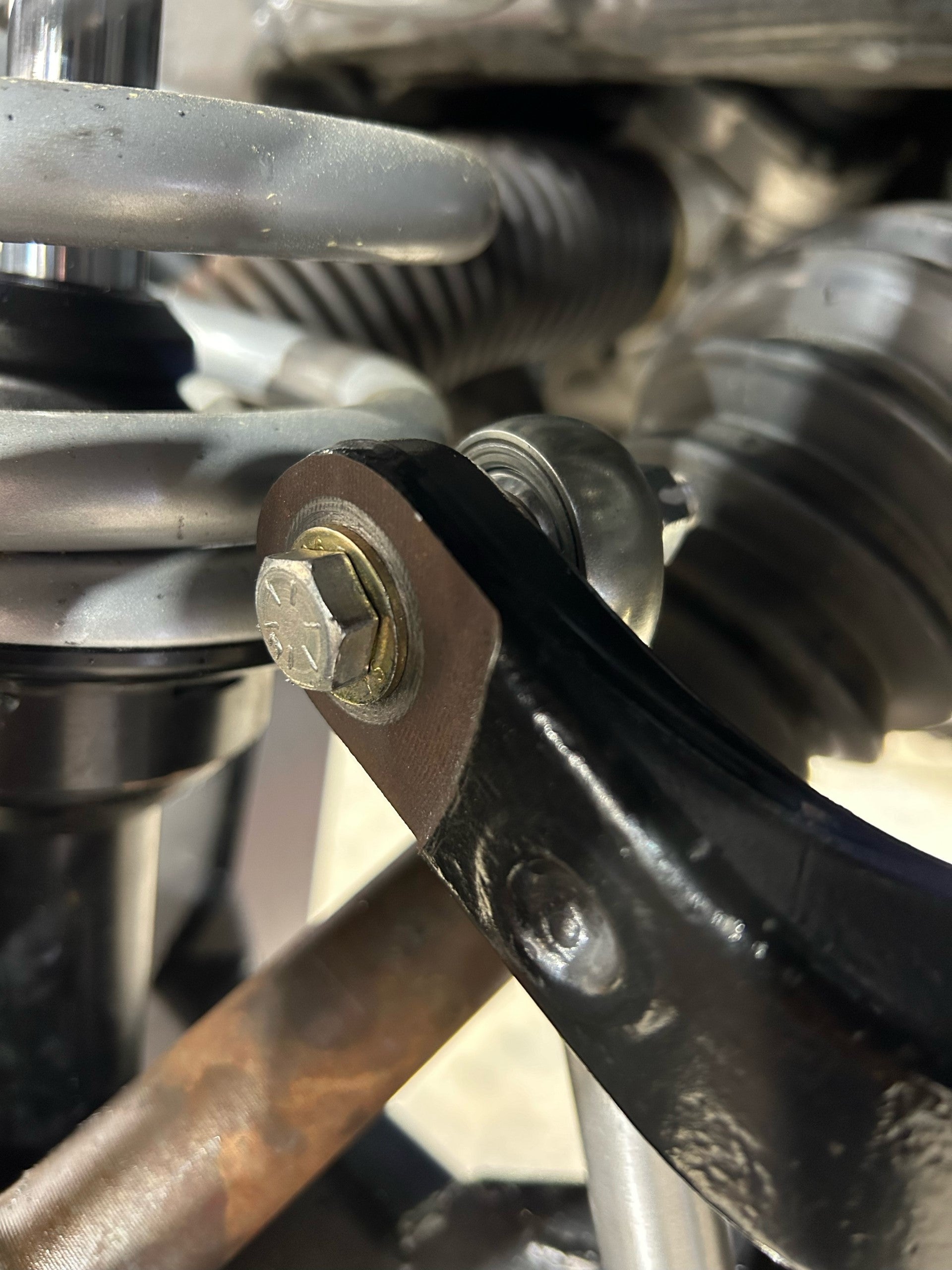 Close-up of Bronco 2021+ sway bar links installed on stock sway bar and fabricated A-arms, showcasing durable construction.
