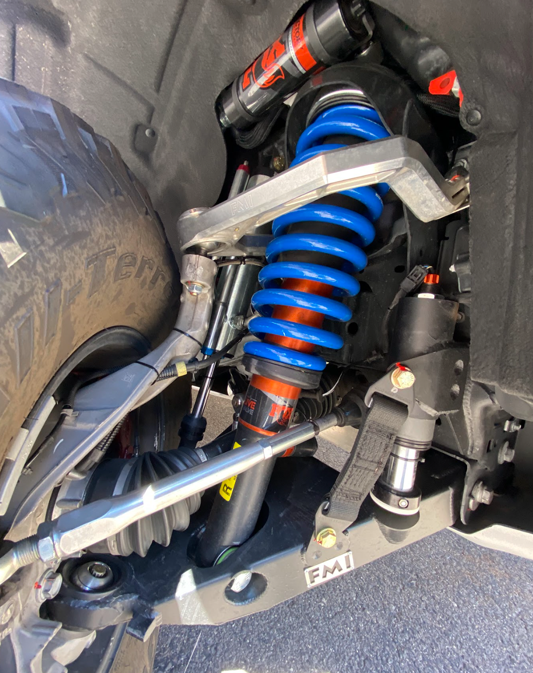 2022+ Bronco Raptor mid travel front suspension kit showcasing blue coilovers and suspension components for enhanced off-road performance.