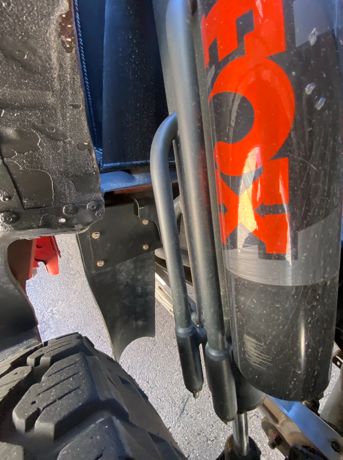 Rear shock guard mud flap frame mount kit for 2017-2024 Gen 2 and Gen 3 Raptor, showcasing shock absorber and mounting details.