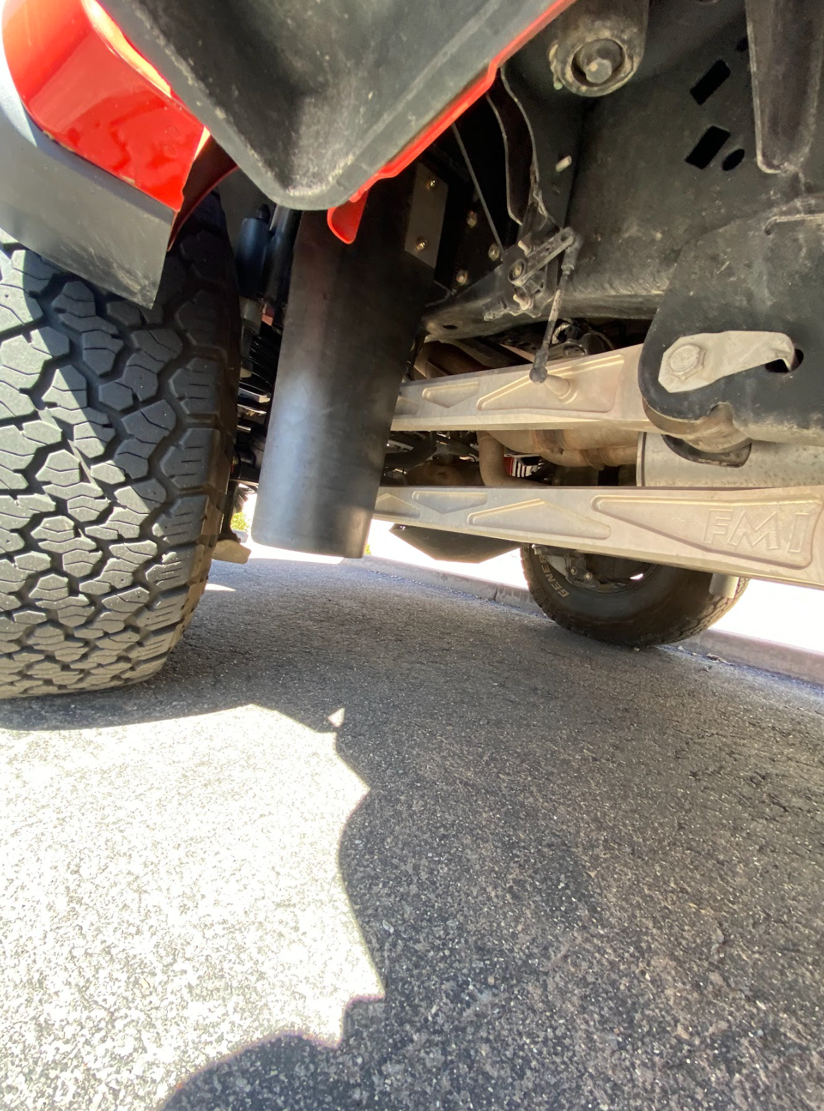Rear view of a 2017-2024 Gen 2 & Gen 3 Raptor showcasing the rear shock guard mud flap frame mount kit installed.