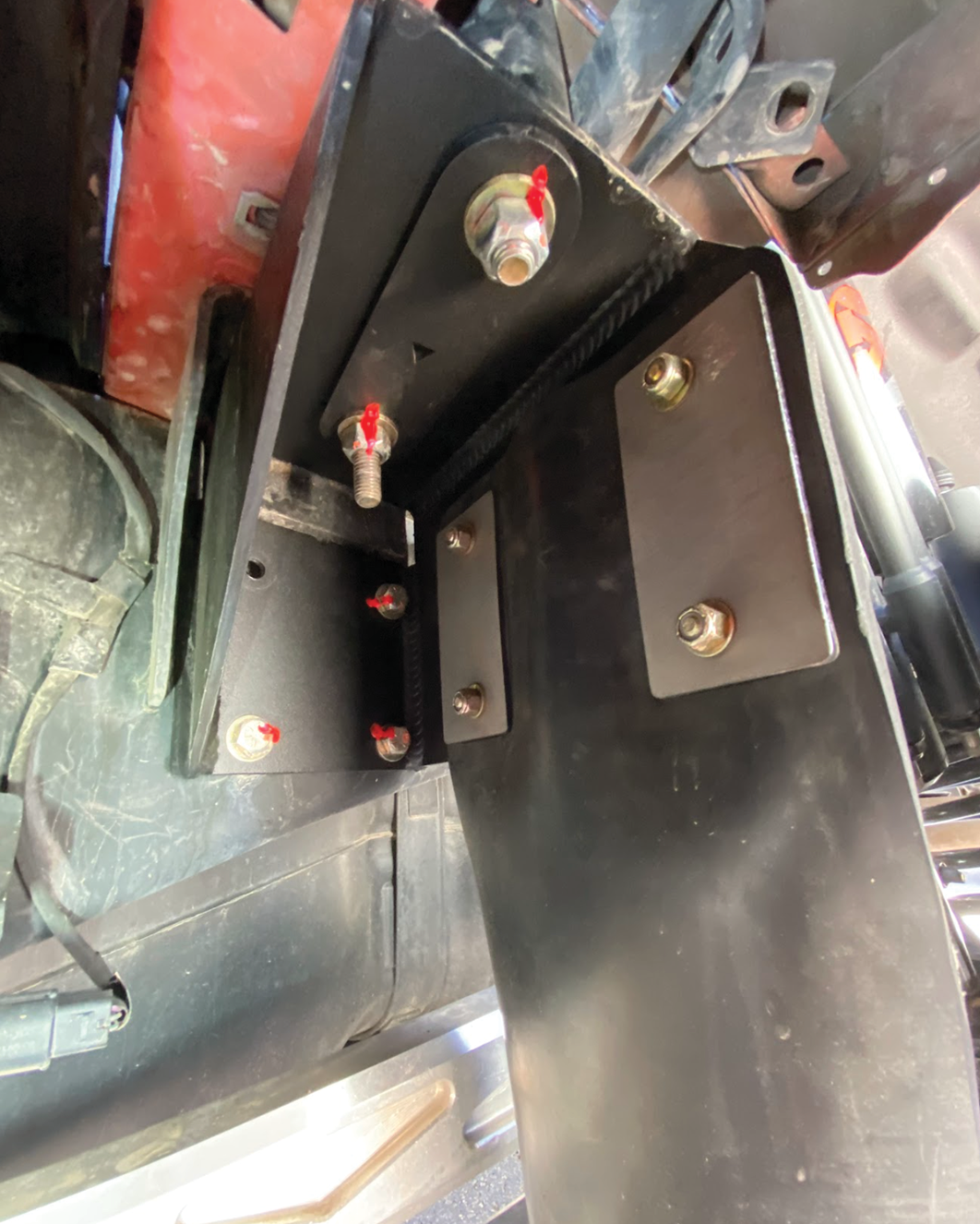 Rear shock guard mud flap frame mount kit for 2017-2024 Gen 2 and Gen 3 Raptor, showcasing installation hardware and design.