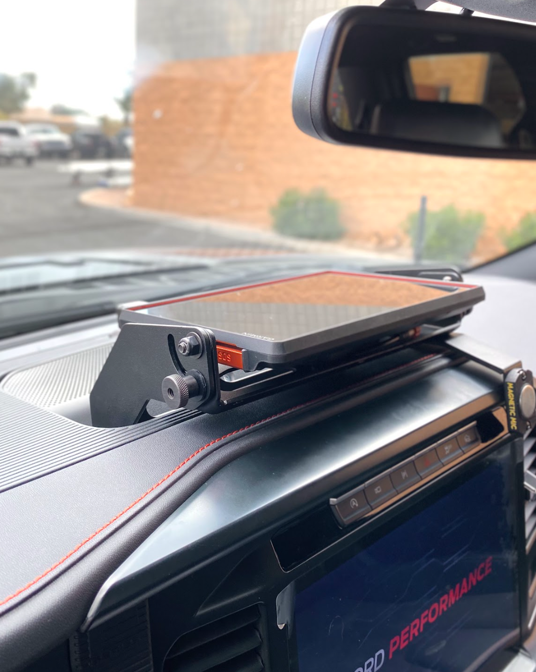 Center dash fold-down GPS mount for 2024+ Gen 3.5 Raptor, designed for Garmin TREAD XL, showcasing sleek installation.