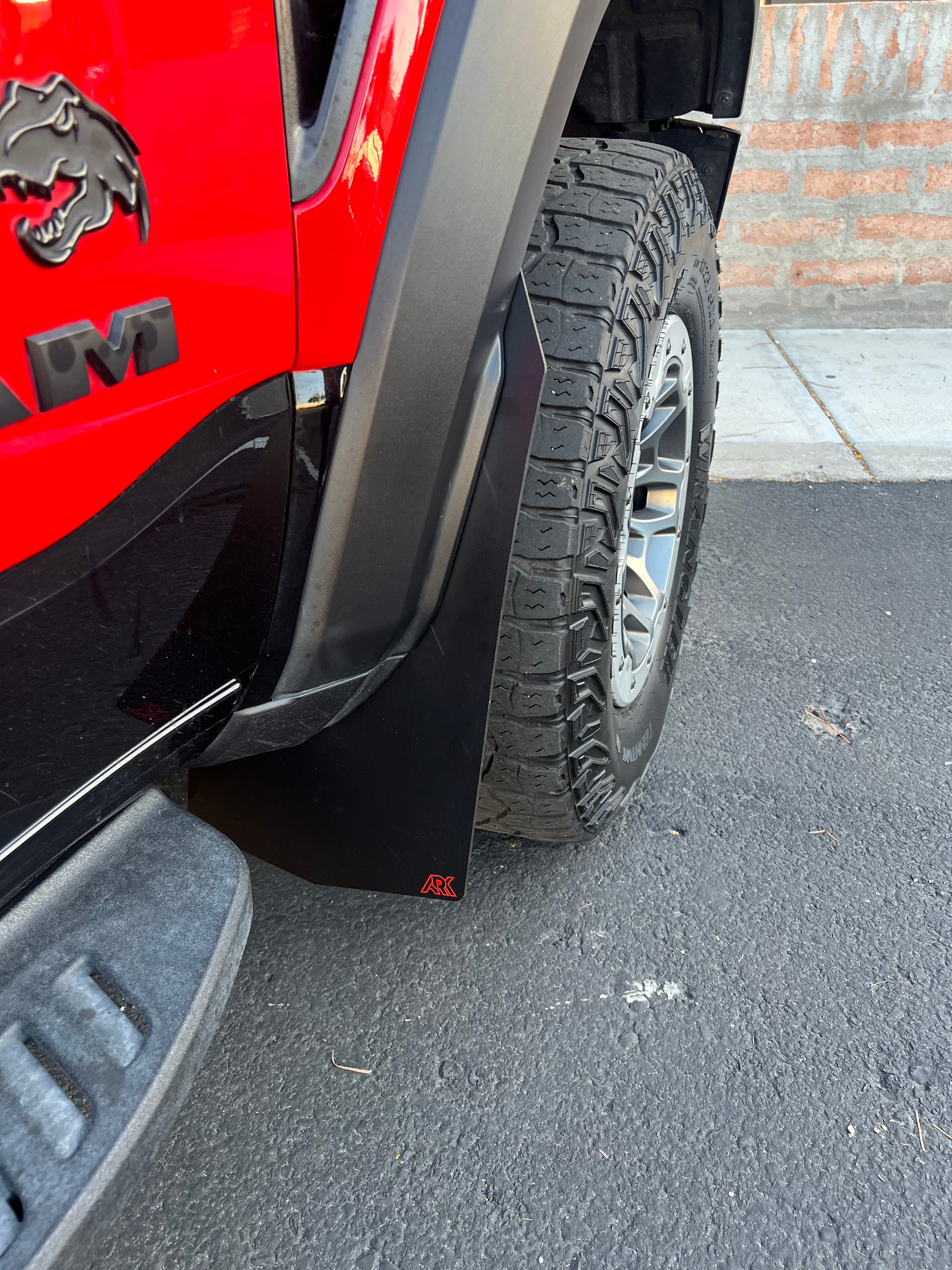 2025+ Dodge RAM RHO Mud Flaps installed on a truck, showcasing durable design and tire protection.