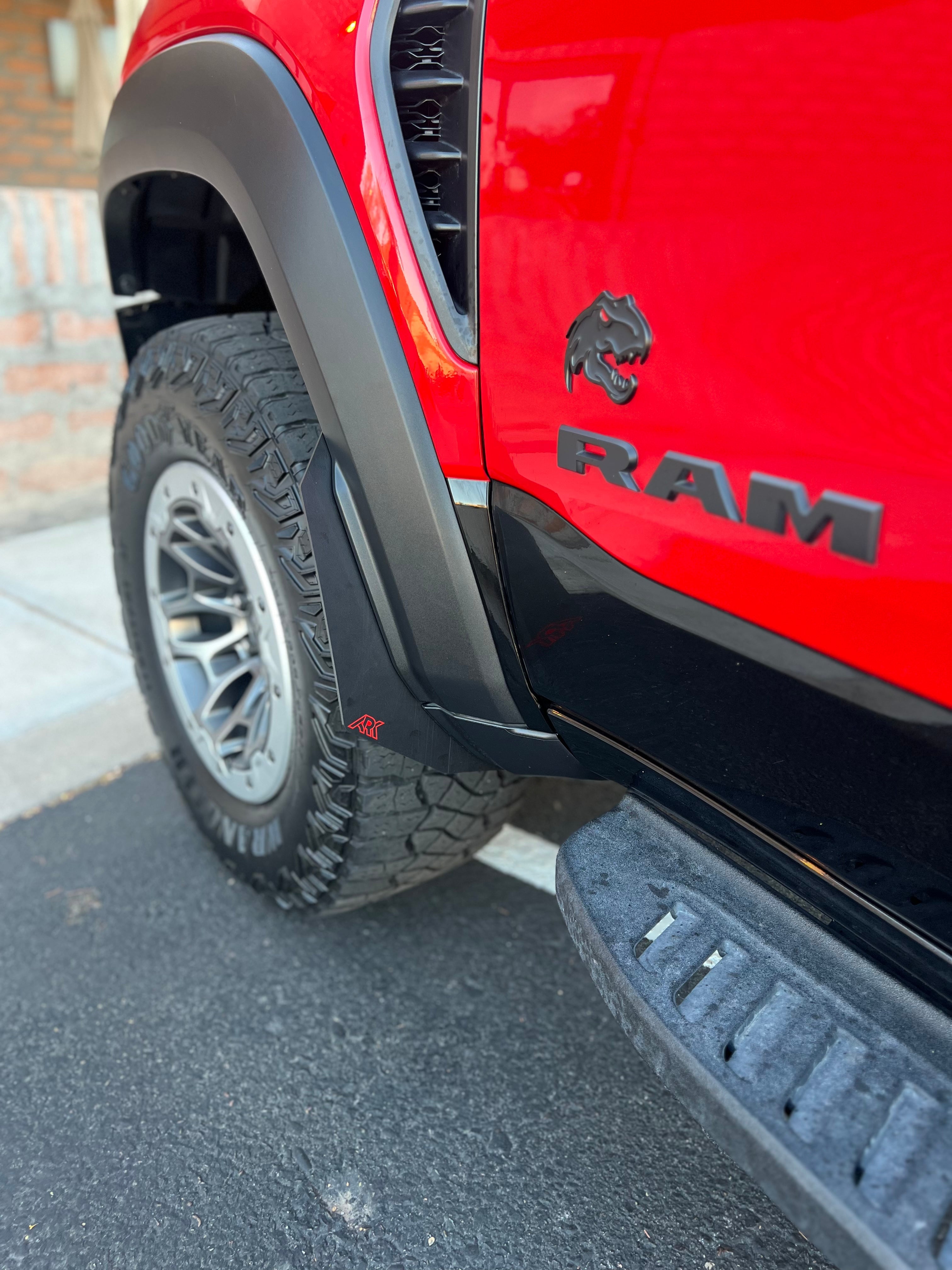 2025+ Dodge RAM RHO Micro Flares installed on a red truck, enhancing the vehicle's rugged appearance and protection.