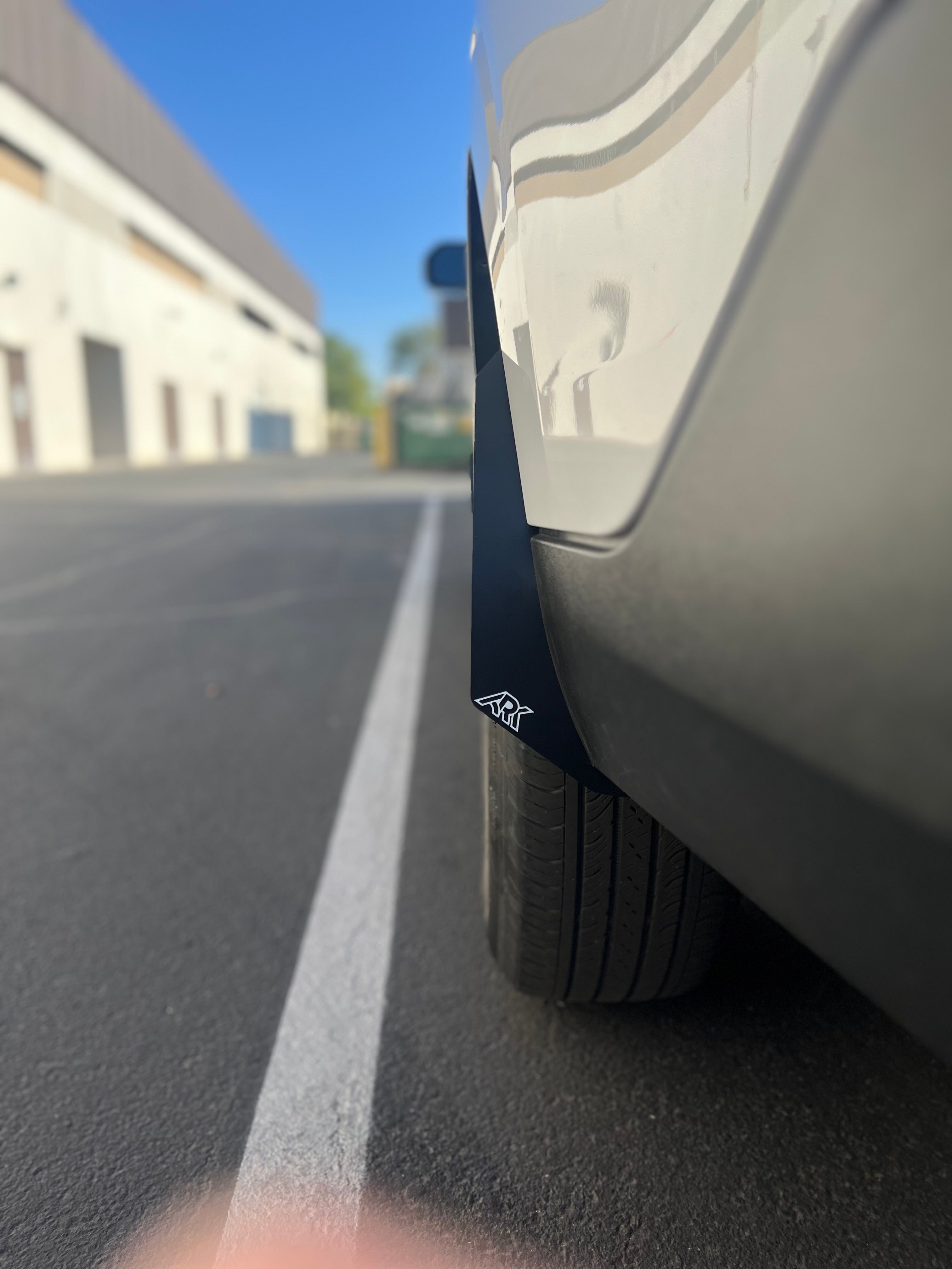 2022+ Ford Maverick Micro Flares showcasing sleek design and fitment on a vehicle tire in a parking lot.