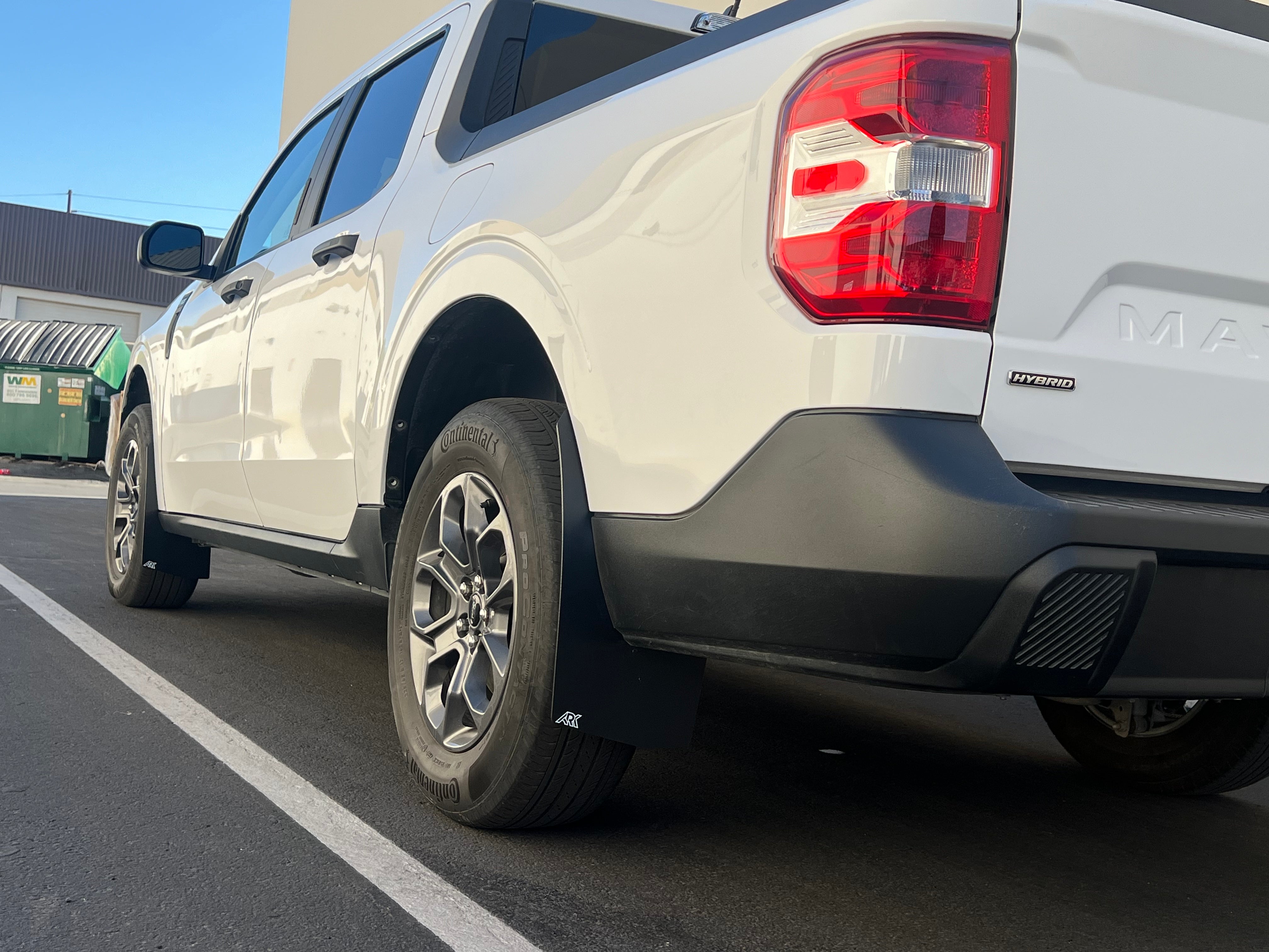 2022+ Ford Maverick with mud flaps installed, showcasing enhanced protection and rugged style in a parking lot setting.
