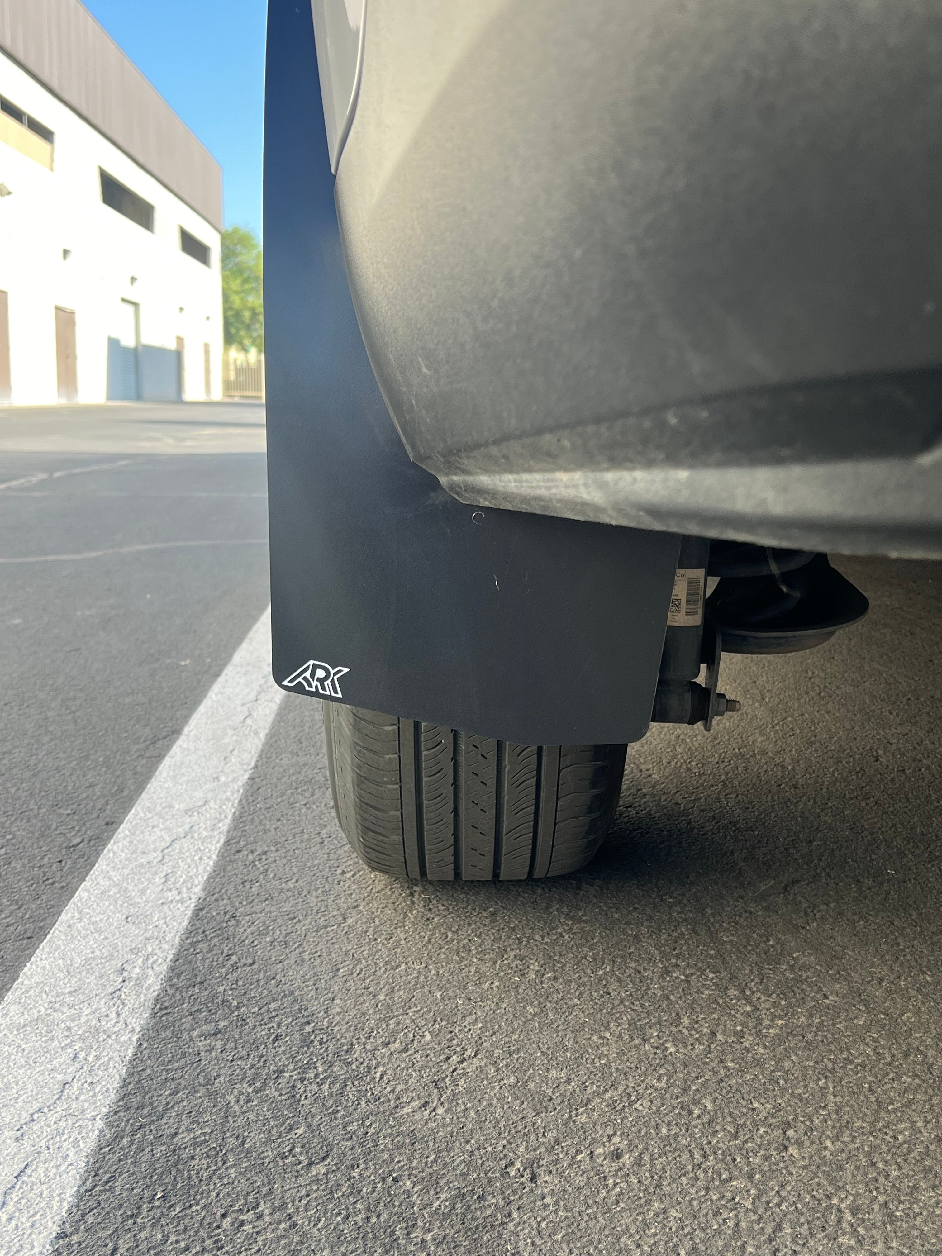 2022+ Ford Maverick mud flaps installed near rear tire, designed to protect against mud and debris.