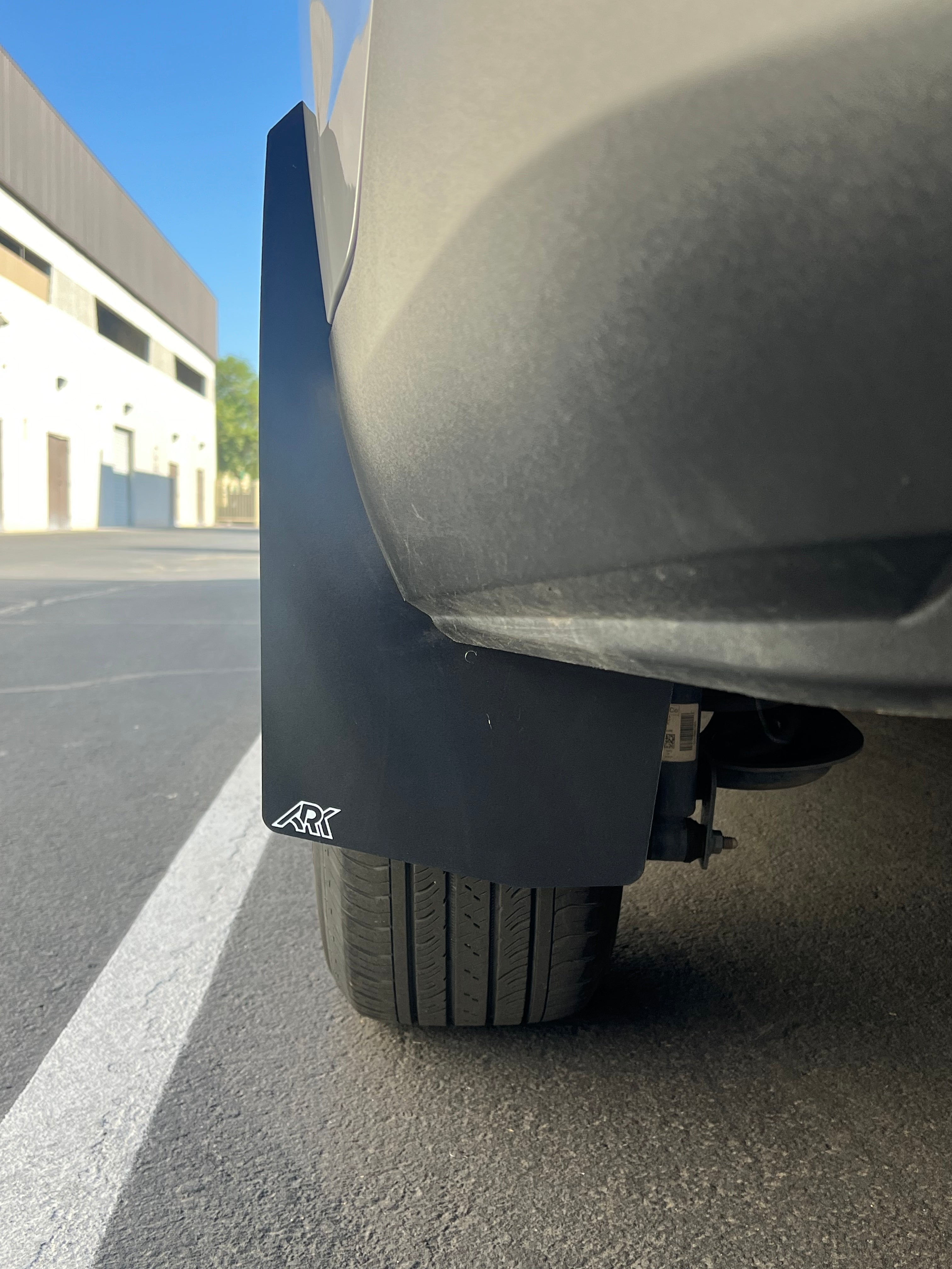 2022+ Ford Maverick mud flaps installed on a vehicle, designed to protect against mud and debris.