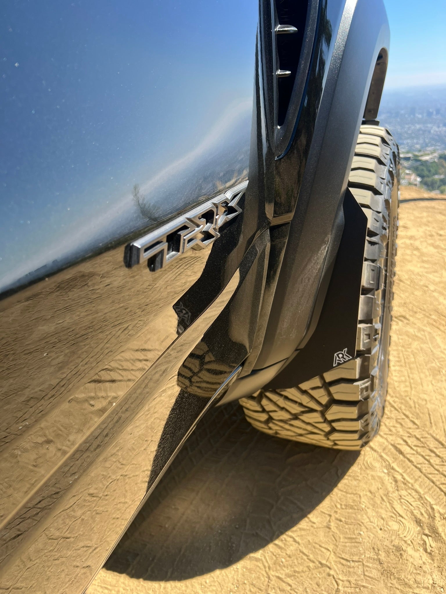 2009-2024 Dodge RAM TRX Micro Flares enhancing tire coverage and style on a rugged terrain backdrop.