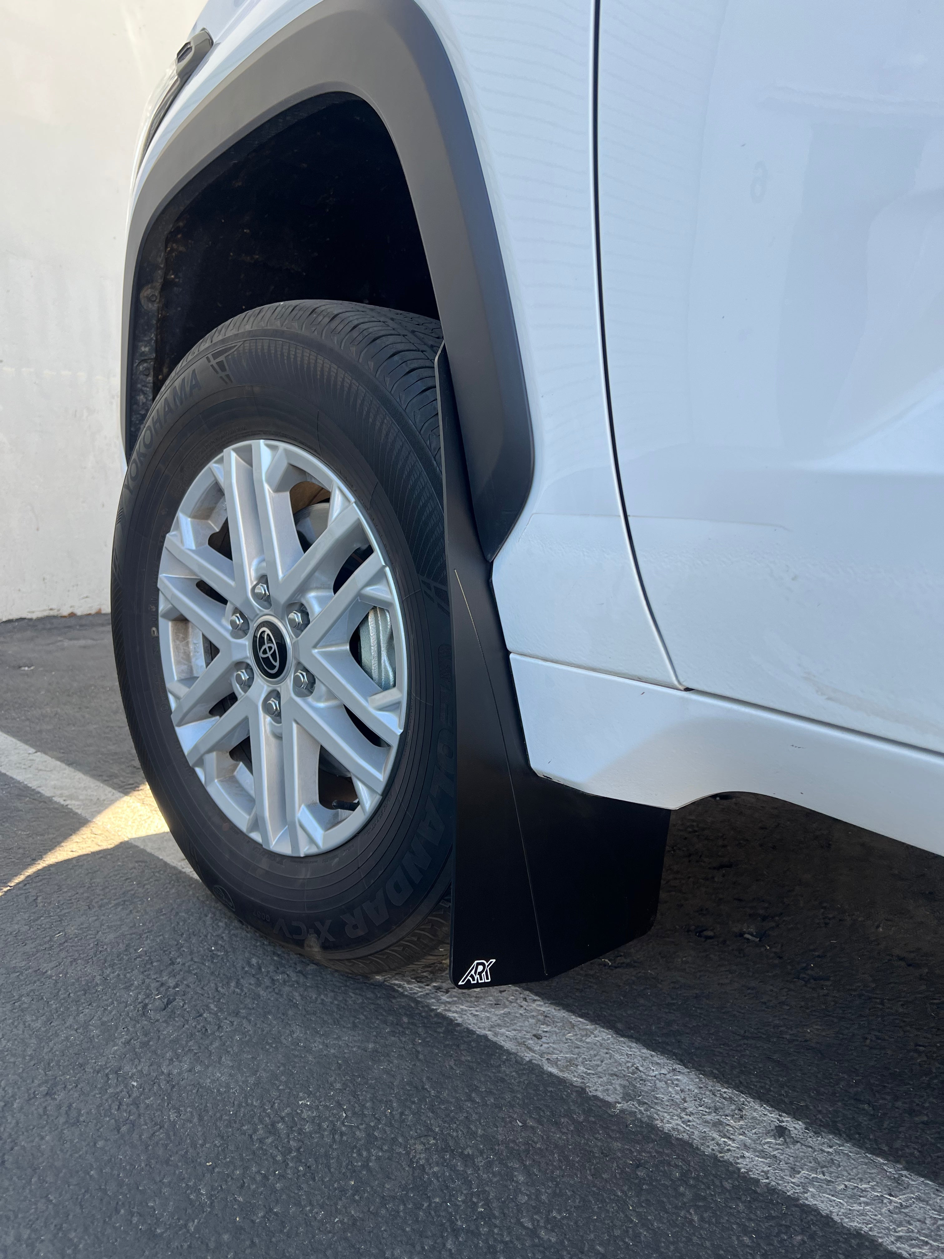 2022+ Toyota Tundra TriXPoly Mudflaps installed on a white truck, providing protection from mud and debris.